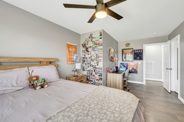 bedroom with wood-type flooring and ceiling fan