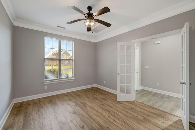 unfurnished room featuring french doors, crown molding, and light hardwood / wood-style flooring