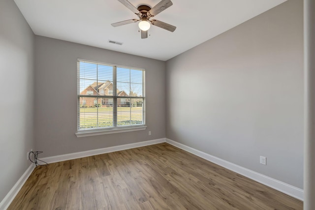 unfurnished room with ceiling fan and wood-type flooring