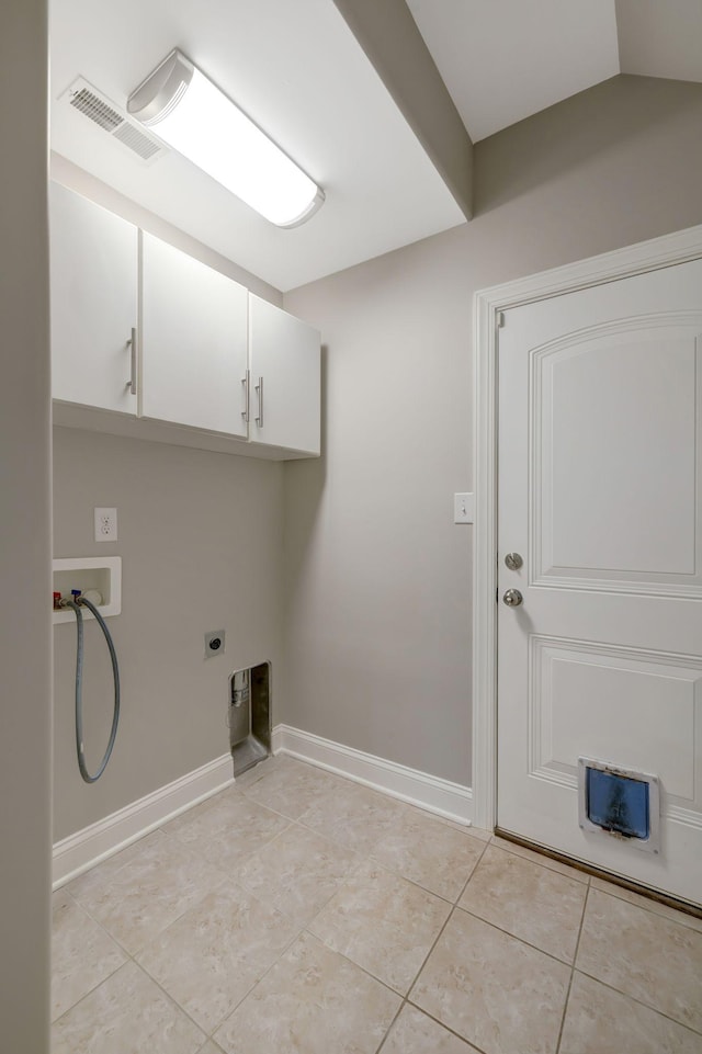 laundry area with electric dryer hookup, hookup for a washing machine, cabinets, and light tile patterned flooring