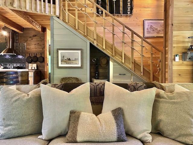 living room with carpet floors and wooden walls