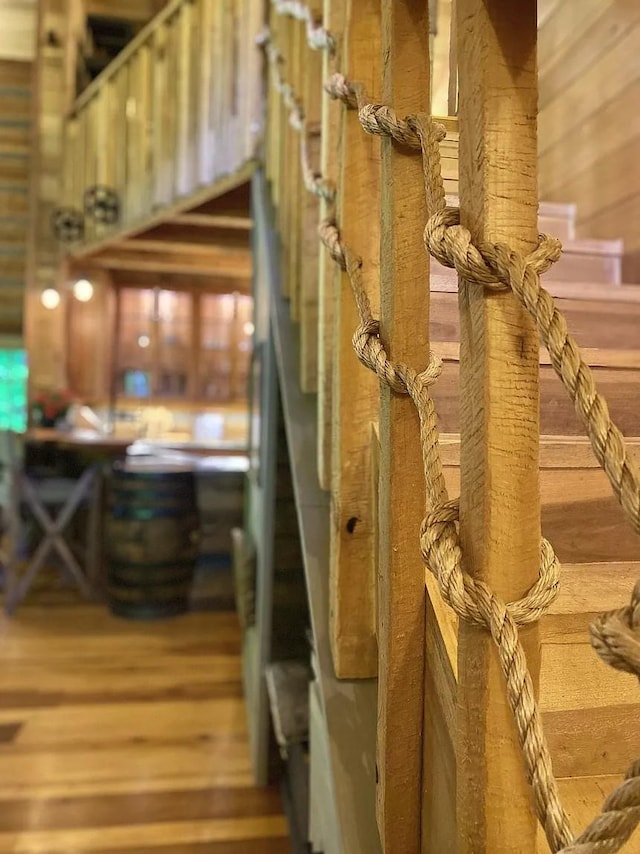 staircase featuring hardwood / wood-style flooring and wood walls