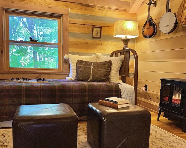 sitting room featuring light hardwood / wood-style floors and wooden walls