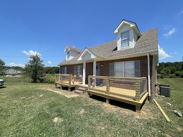 view of front of home featuring a deck, a front lawn, and cooling unit