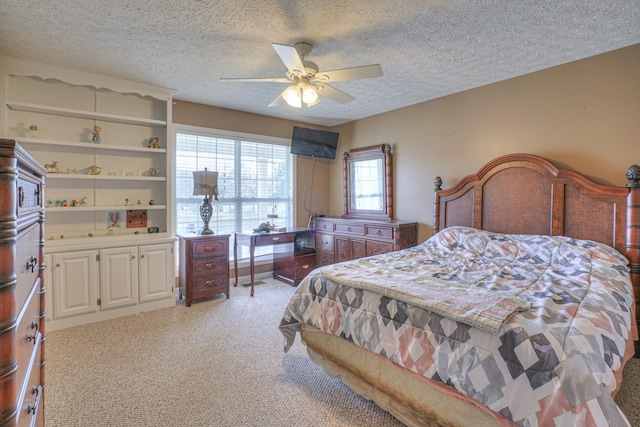 carpeted bedroom with ceiling fan and a textured ceiling