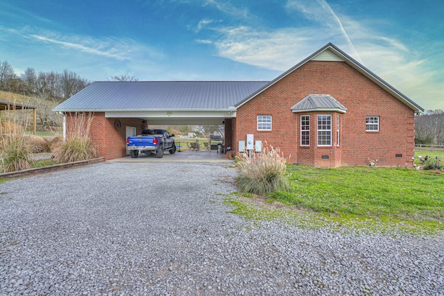 view of home's exterior featuring a lawn and a carport