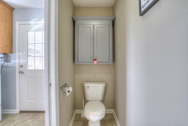 bathroom with a textured ceiling and toilet