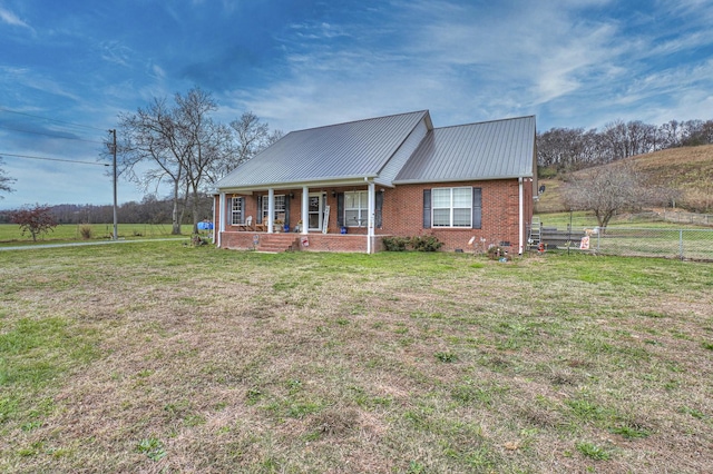 view of front of property with covered porch and a front yard