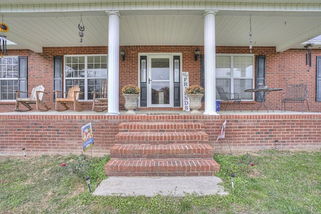 view of exterior entry featuring a porch