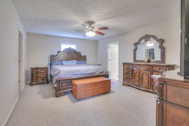 carpeted bedroom with a textured ceiling and ceiling fan