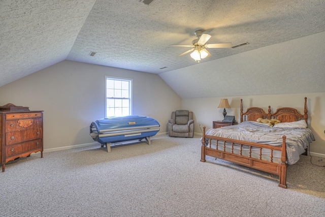 carpeted bedroom with a textured ceiling, ceiling fan, and lofted ceiling