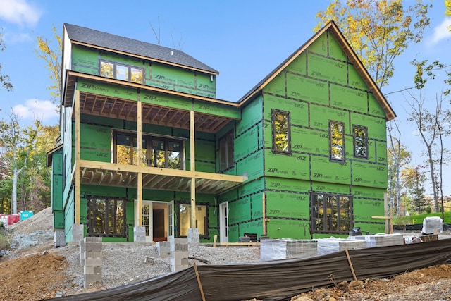 rear view of property with a balcony