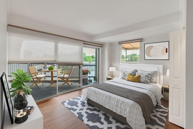 bedroom with access to outside and hardwood / wood-style floors