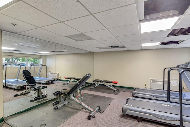 workout area featuring a paneled ceiling