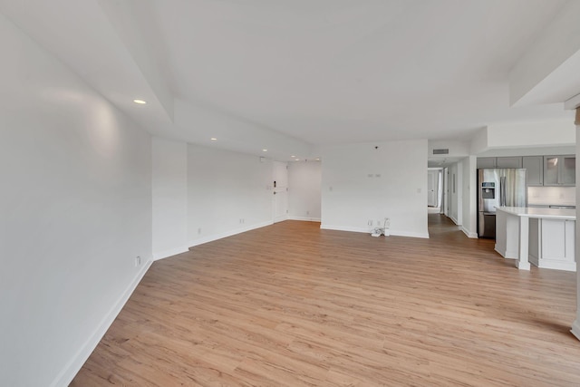 unfurnished living room with light hardwood / wood-style flooring