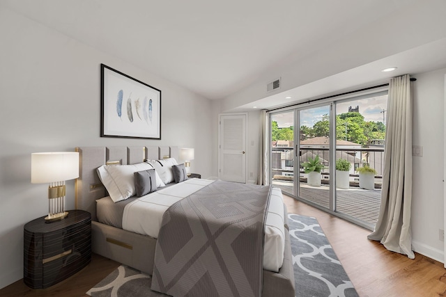 bedroom featuring light hardwood / wood-style floors and access to exterior