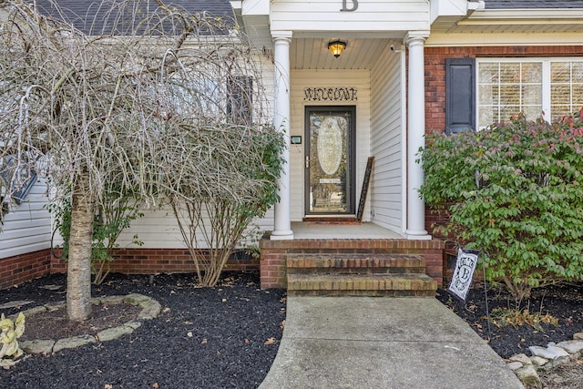 doorway to property with roof with shingles