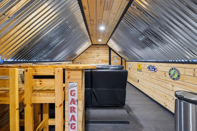 interior space with lofted ceiling, wood ceiling, and wooden walls