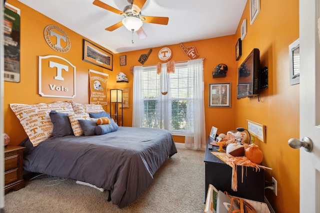 bedroom with a ceiling fan and light colored carpet