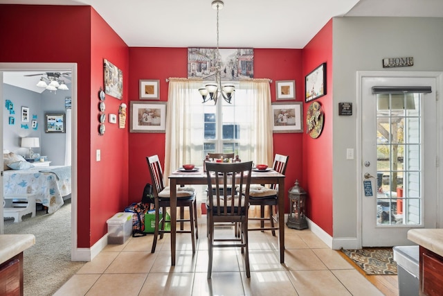 dining space featuring baseboards, light tile patterned flooring, and a notable chandelier