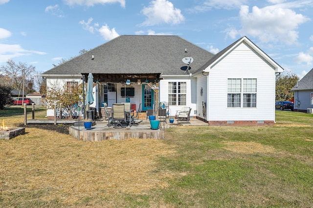 back of property featuring a shingled roof, crawl space, a patio area, and a yard