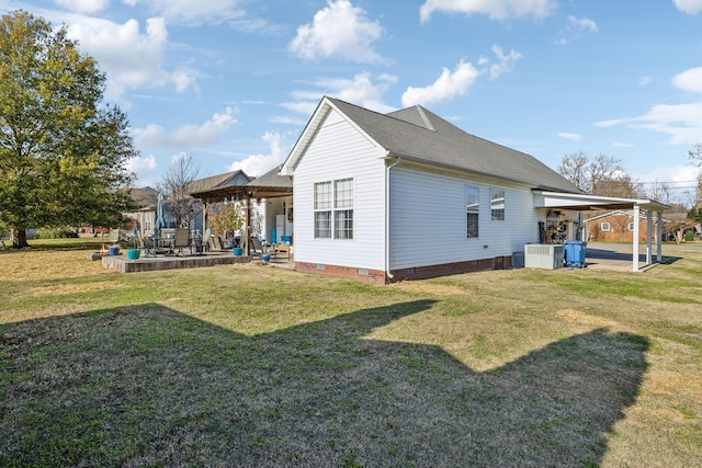 view of home's exterior with roof with shingles, a patio, central air condition unit, a lawn, and crawl space