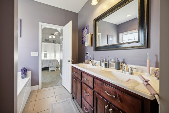 ensuite bathroom featuring a sink, tile patterned flooring, double vanity, and connected bathroom