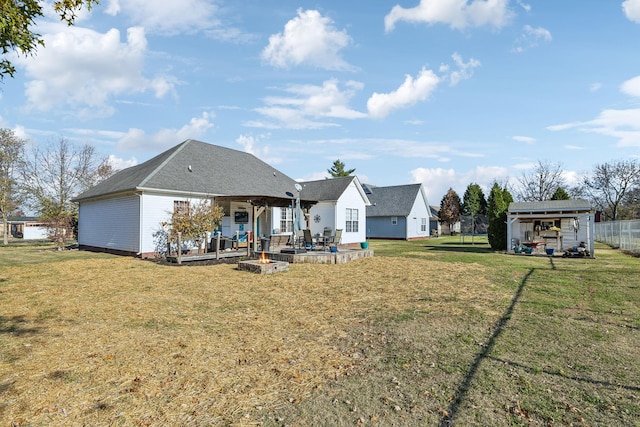 back of property featuring a carport, a yard, and a patio