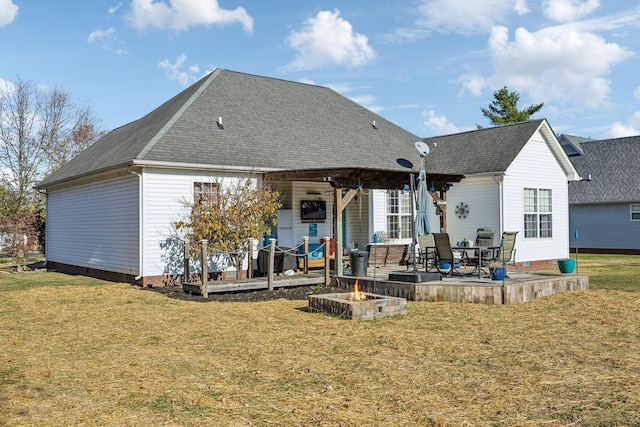 rear view of house featuring crawl space, a patio area, a yard, and roof with shingles