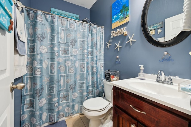 bathroom featuring curtained shower, vanity, toilet, and tile patterned floors