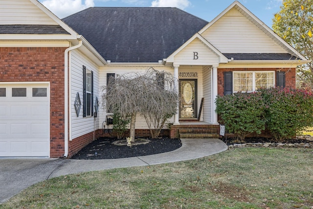 view of front of property featuring a garage, brick siding, a front yard, and roof with shingles