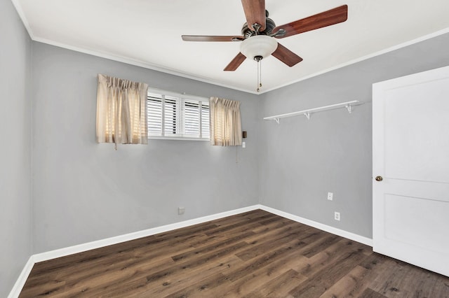 spare room featuring ceiling fan, dark hardwood / wood-style flooring, and crown molding