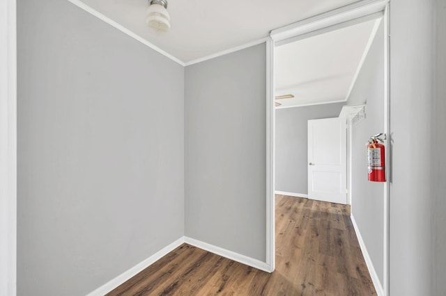 spare room featuring crown molding and dark wood-type flooring