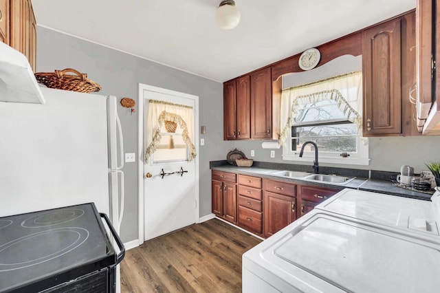 kitchen featuring range, dark hardwood / wood-style floors, white fridge, and sink