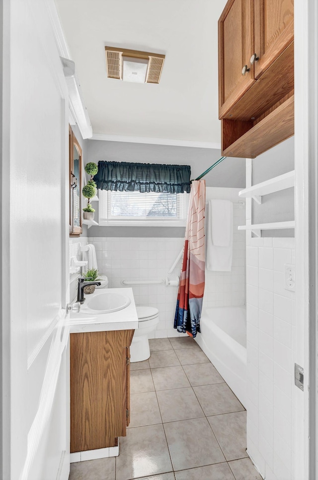 full bathroom featuring shower / bath combo, vanity, tile walls, tile patterned flooring, and toilet