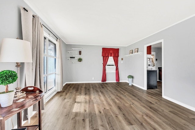 unfurnished living room featuring cooling unit, wood-type flooring, and crown molding