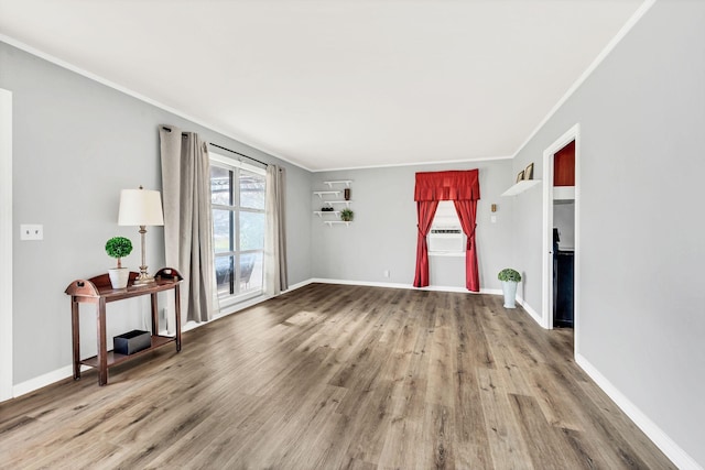 empty room with hardwood / wood-style flooring and ornamental molding