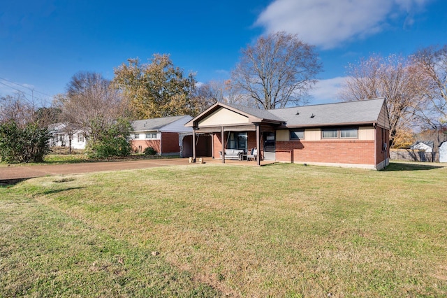 view of front facade featuring a front lawn and a patio