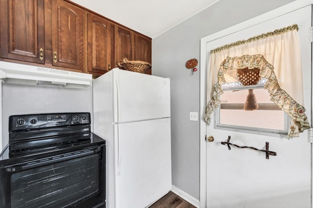 kitchen with electric range, dark hardwood / wood-style floors, and white refrigerator