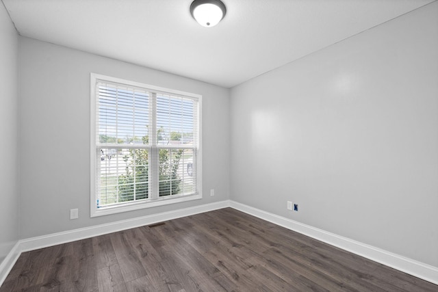 spare room featuring dark hardwood / wood-style floors