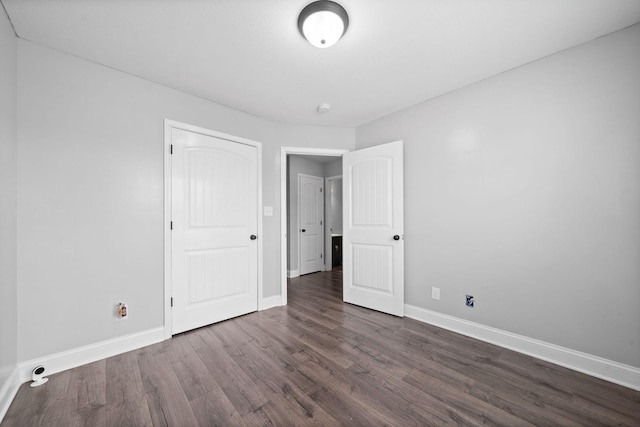 unfurnished bedroom with dark hardwood / wood-style floors