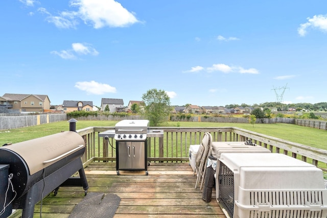 wooden deck with a grill and a yard