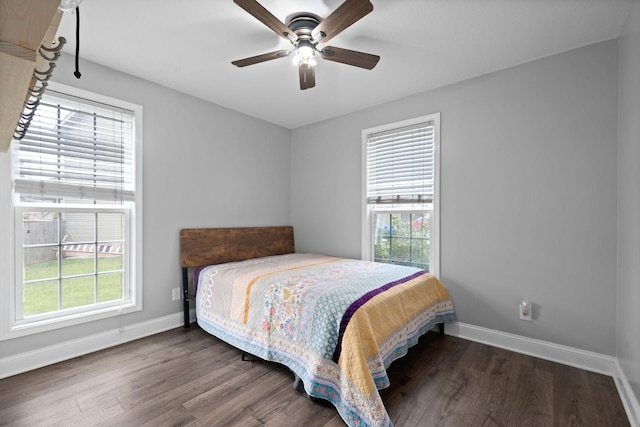 bedroom featuring ceiling fan and dark hardwood / wood-style floors