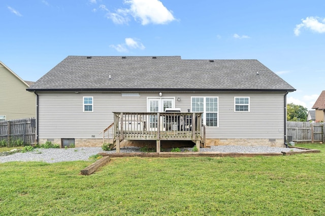 back of property featuring a lawn and a wooden deck