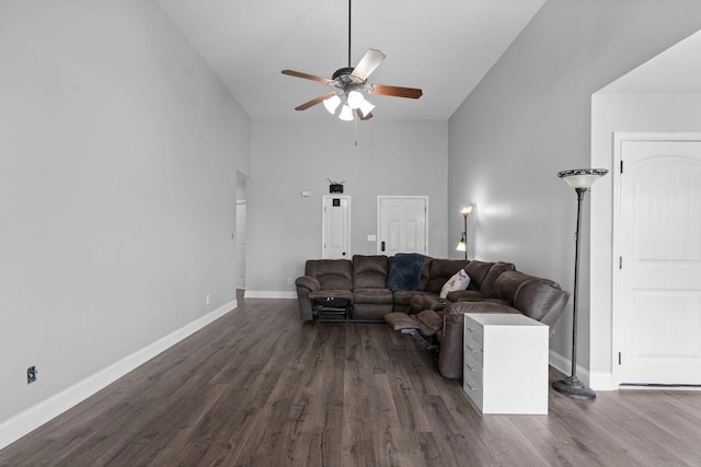 living room with ceiling fan, dark wood-type flooring, and high vaulted ceiling