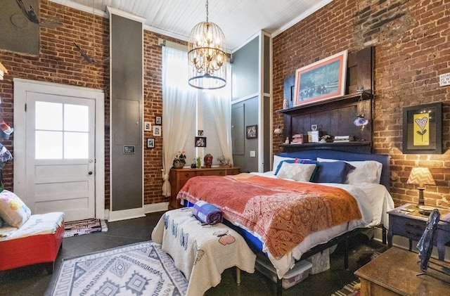 bedroom featuring ornamental molding, a notable chandelier, and brick wall