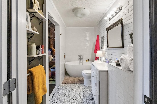 bathroom featuring tile patterned flooring, a tub to relax in, crown molding, a textured ceiling, and vanity