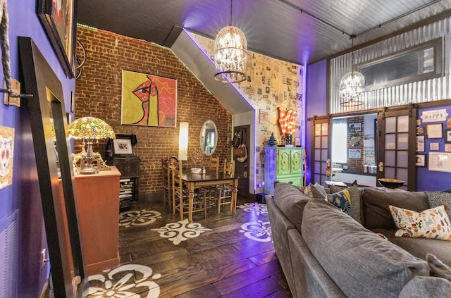 living room with a chandelier, dark hardwood / wood-style floors, and brick wall