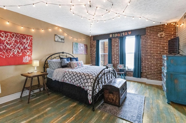 bedroom with a textured ceiling and dark hardwood / wood-style flooring