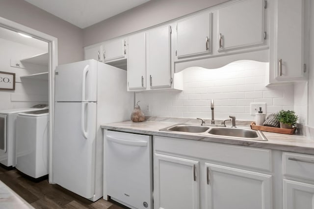 kitchen featuring white appliances, white cabinets, sink, separate washer and dryer, and dark hardwood / wood-style flooring